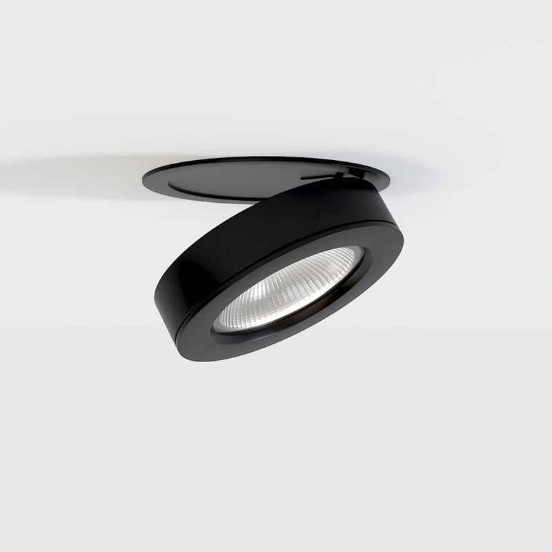 Black adjustable recessed downlight with LED lens mounted in white ceiling.