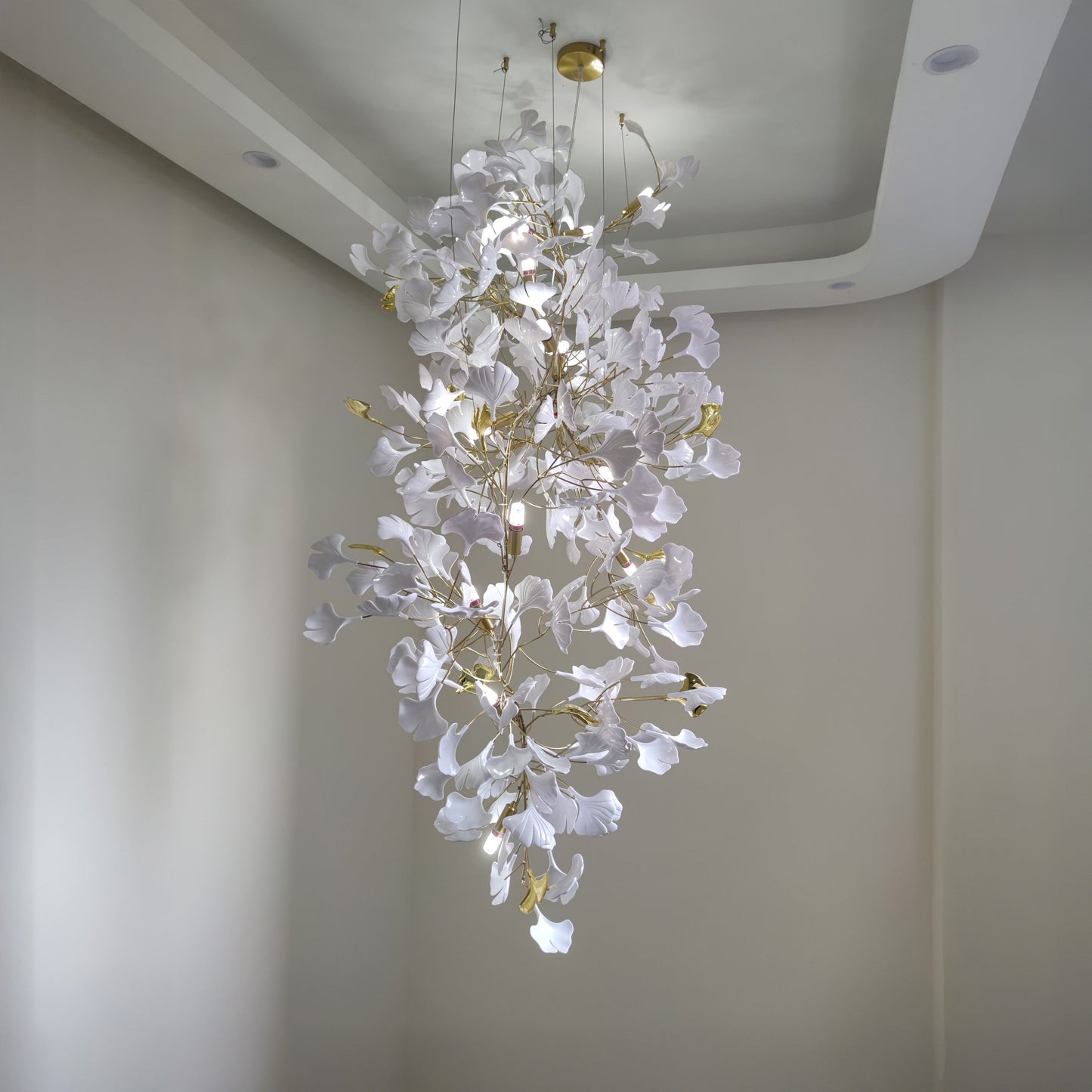 Compact white ceramic foyer chandelier with gold details.