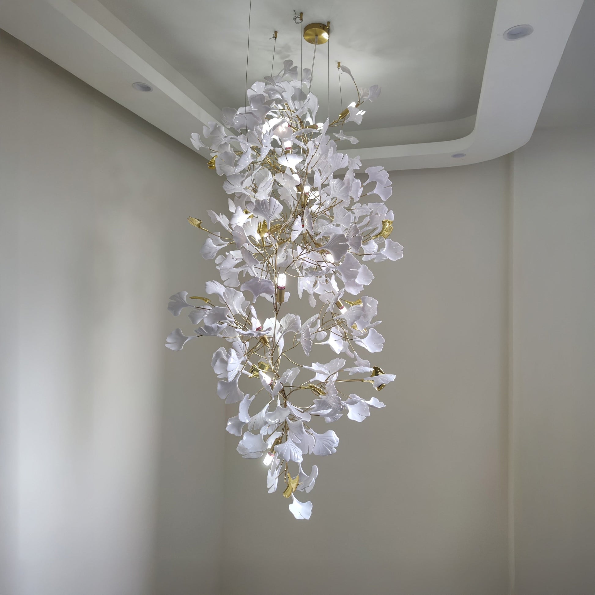 Compact white ceramic foyer chandelier with gold details.