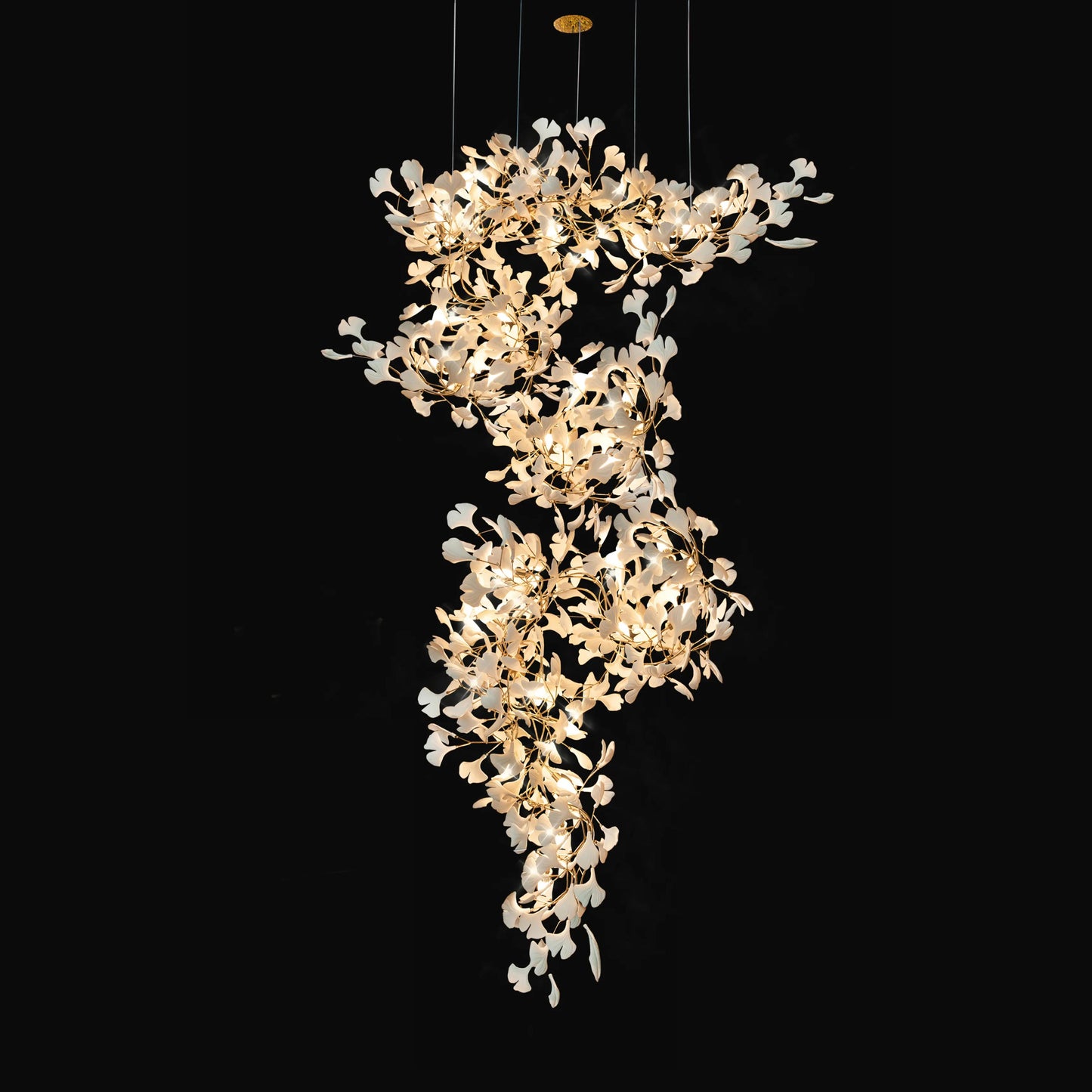 Large ceramic ginkgo chandelier with white leaves on a black background.