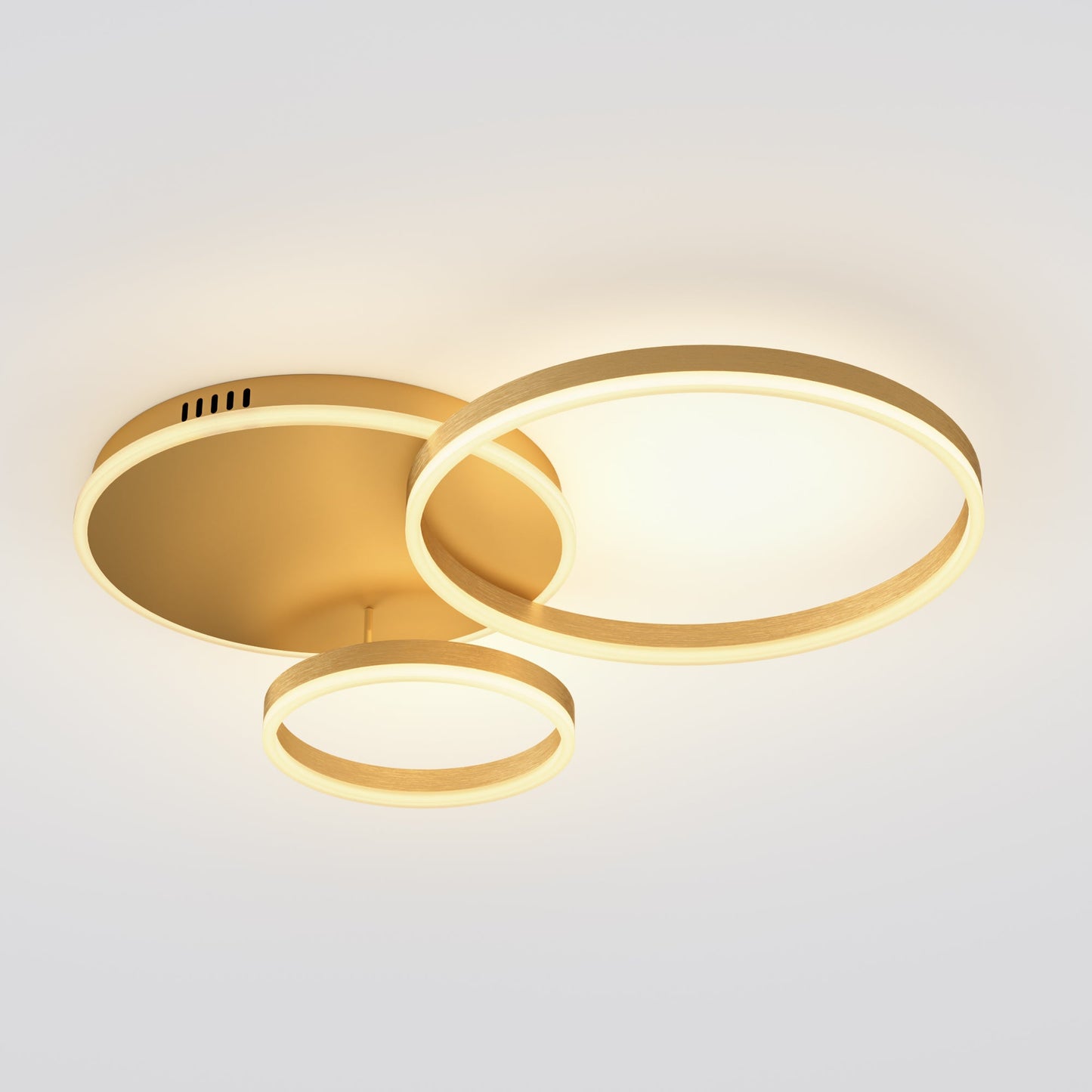 A gold circle light with three staggered LED rings, designed to add soft movement and ambient warmth to a modern ceiling.