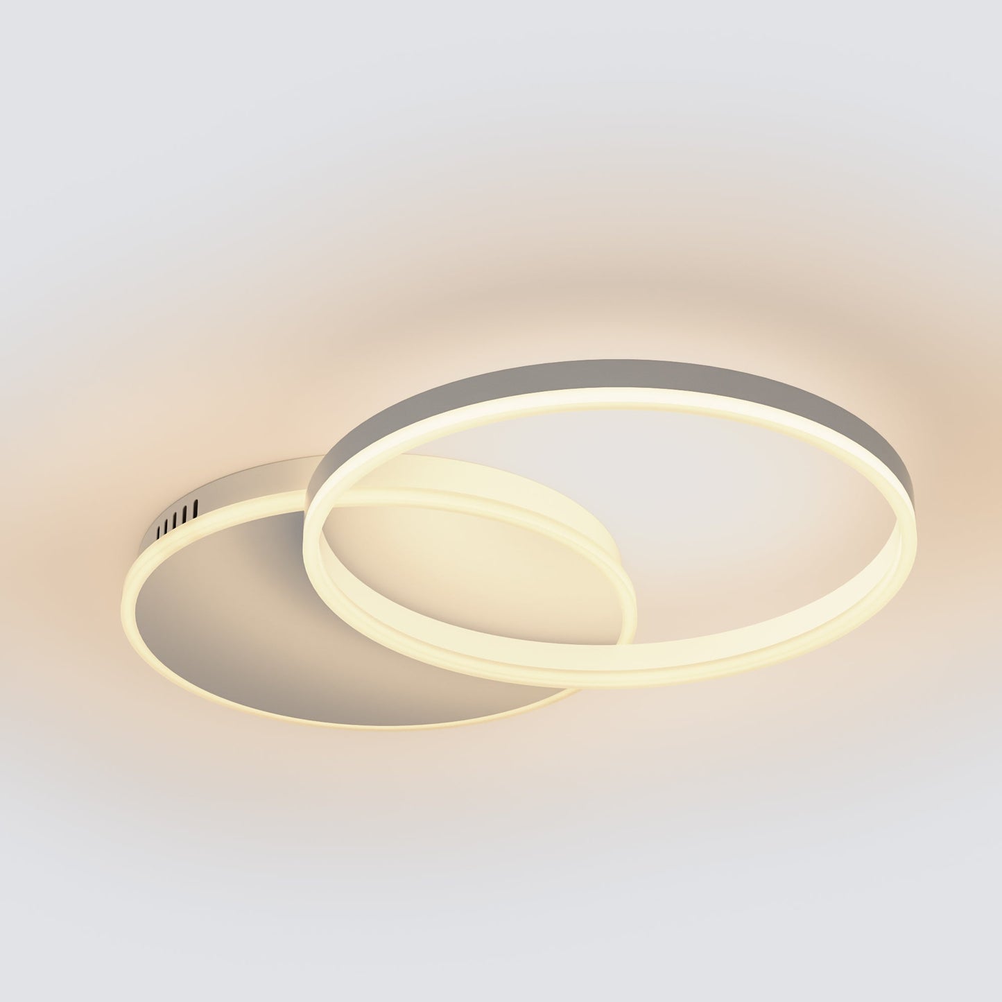 Modern two-ring LED ceiling light fixture in a minimalist design, featuring one large outer ring and one smaller concentric inner ring, shown illuminated against a plain light gray background.