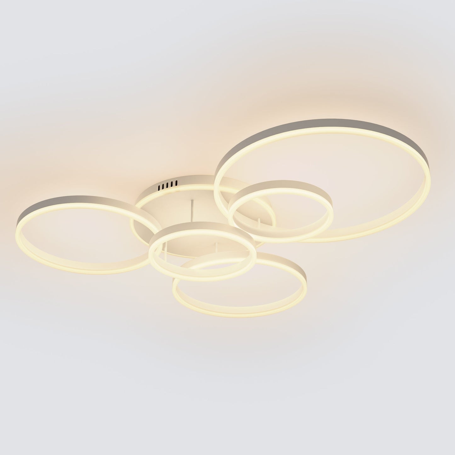 Modern multi-ring LED ceiling light fixture with a warm white glow, featuring five interlocking circular rings in a minimalist design.