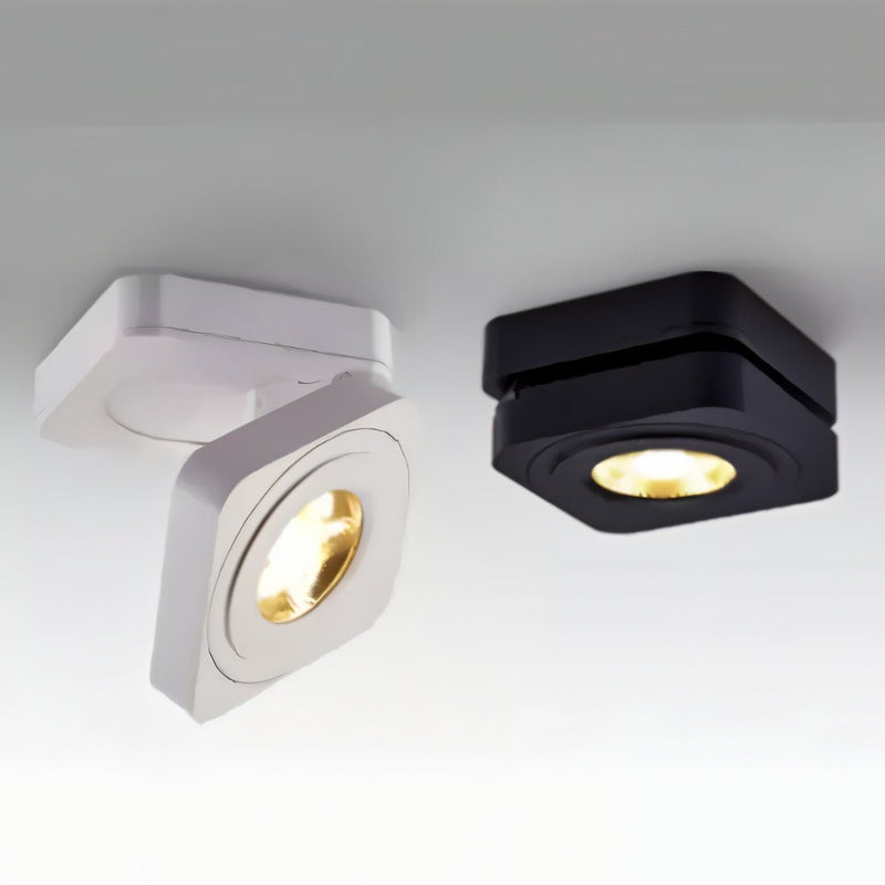 Two square downlight fixtures in white and black finishes with warm LED bulbs against a gray background.