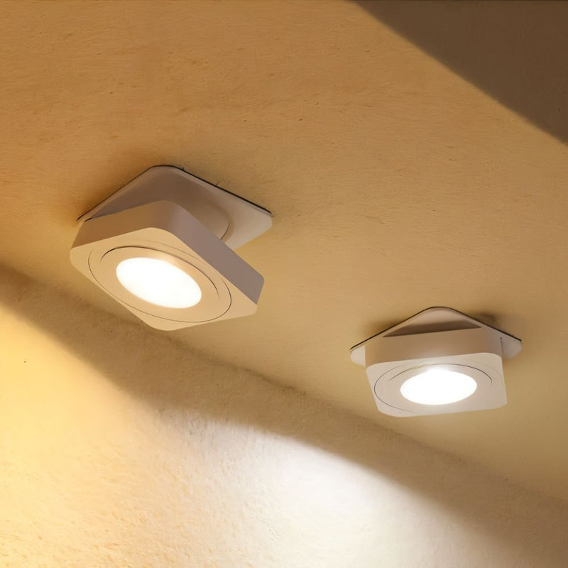 Two square white recessed ceiling lights with bright LED panels mounted in a cream-colored ceiling.