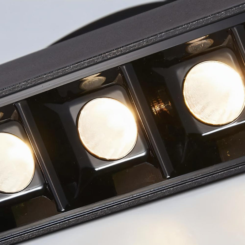 Black recessed downlight fixture with three illuminated circular trim rings, shown against white background.