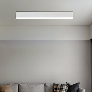 White rectangular LED ceiling light fixture mounted above a gray sofa with decorative pillows.