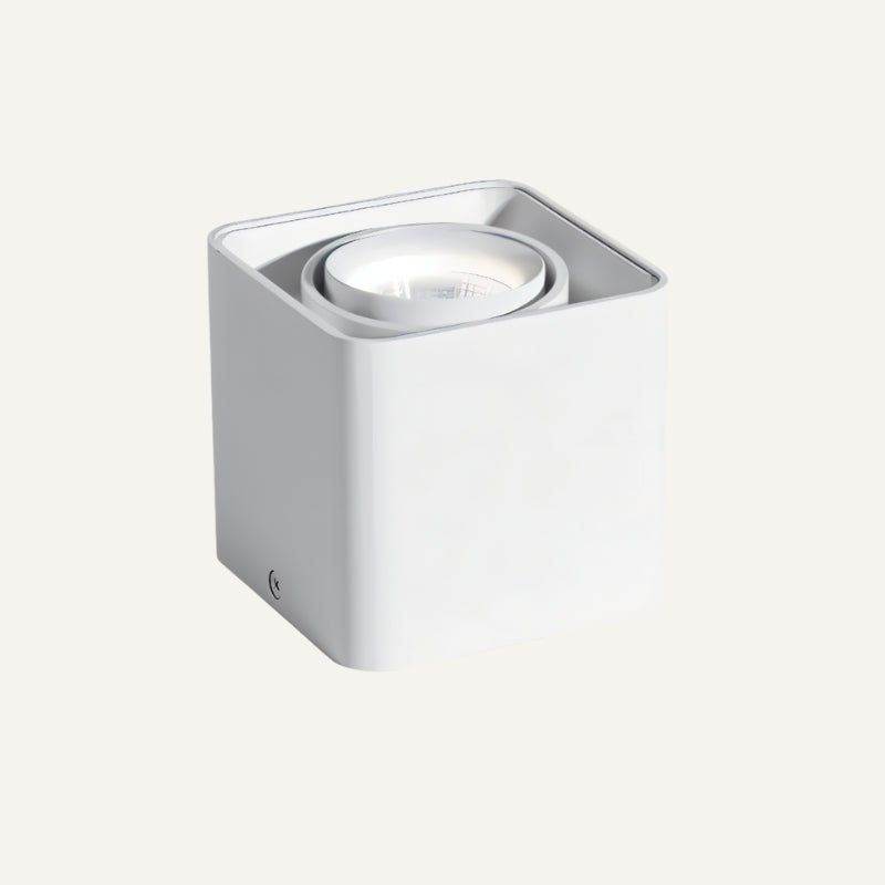 White cylindrical wall-mounted downlight fixture with recessed LED lamp on neutral background.