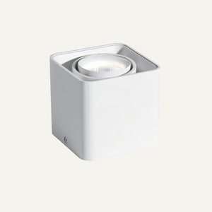 White cylindrical wall-mounted downlight fixture with recessed LED lamp on neutral background.