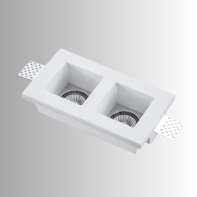 "Trimless recessed downlight fixture with dual square openings, crafted from gypsum and aluminum, offering a sleek and minimalist design for focused, efficient lighting."
