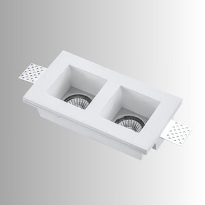 "Trimless recessed downlight fixture with dual square openings, crafted from gypsum and aluminum, offering a sleek and minimalist design for focused, efficient lighting."