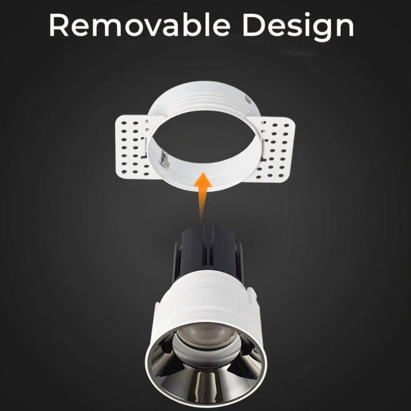Trimless recessed downlight with white finish and removable ring design shown disassembled on dark background.