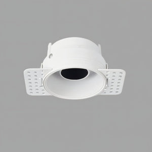 White recessed downlight with adjustable trim and perforated mounting wings on gray background.