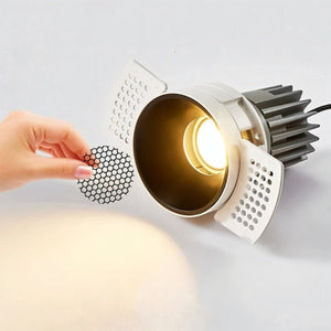 White recessed downlight with gold interior and heat sink, shown illuminated with interchangeable diffuser filter.