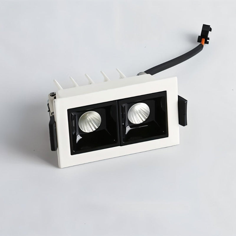 White recessed downlight with dual black reflectors and adjustable trim on light gray background.