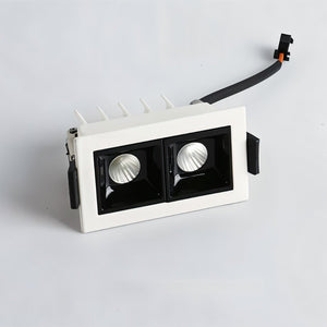 White recessed downlight with dual black reflectors and adjustable trim on light gray background.