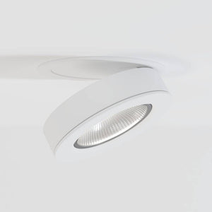 White recessed downlight with adjustable trim and reflective lens mounted on ceiling.